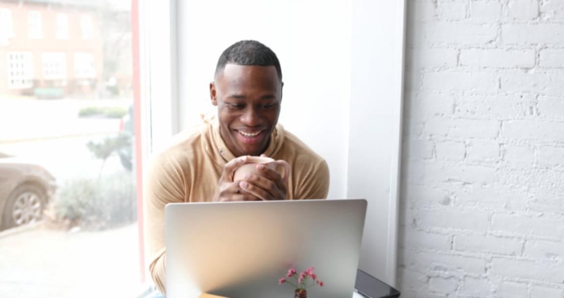 Journalist working at a desk with notes and a laptop